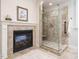 Bathroom featuring a tiled fireplace and a glass-enclosed shower with a built-in seat at 101 Temple Gate Dr, Cary, NC 27518
