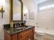 Bathroom features a granite vanity, framed mirror, and tiled shower-tub combination at 101 Temple Gate Dr, Cary, NC 27518