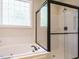 Elegant bathroom featuring a separate glass shower and a luxurious soaking tub at 101 Temple Gate Dr, Cary, NC 27518