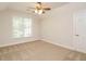 Bedroom showcasing neutral carpet, a ceiling fan, and a window providing natural light at 101 Temple Gate Dr, Cary, NC 27518