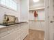 A closet with a window above a vanity and open hanging rods with interior carpet at 101 Temple Gate Dr, Cary, NC 27518