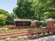 The Danbury at Regency entrance sign with a brick base and manicured flowerbeds in a lush, green landscape at 101 Temple Gate Dr, Cary, NC 27518