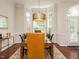 Spacious dining room features a modern chandelier, large windows, and a view of the front door at 101 Temple Gate Dr, Cary, NC 27518