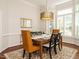 Elegant dining room with a modern chandelier, large windows, and a stylish area rug at 101 Temple Gate Dr, Cary, NC 27518