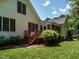 Rear exterior view of home, featuring a screened porch, wooden deck, and lush green lawn at 101 Temple Gate Dr, Cary, NC 27518