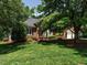 Beautiful brick home surrounded by lush greenery and mature trees, offering a serene and private setting at 101 Temple Gate Dr, Cary, NC 27518