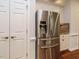 Stainless steel refrigerator complemented by white cabinetry and a well-lit pantry with tile backsplash at 101 Temple Gate Dr, Cary, NC 27518