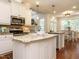 Elegant kitchen with white cabinets, granite countertops, and stainless steel appliances at 101 Temple Gate Dr, Cary, NC 27518
