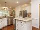 Bright kitchen with white cabinetry, stainless appliances, granite countertops, and hardwood flooring at 101 Temple Gate Dr, Cary, NC 27518