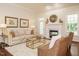 Cozy living room with a fireplace, plush seating, and ample natural light at 101 Temple Gate Dr, Cary, NC 27518