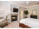 Inviting main bedroom with fireplace, ceiling fan, and comfortable seating area at 101 Temple Gate Dr, Cary, NC 27518