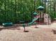 Community playground including a slide, climbing structure, and spring riders with surrounding shade at 101 Temple Gate Dr, Cary, NC 27518