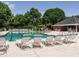 Community pool featuring many lounge chairs, lifeguard stand, and lush landscaping surrounding the area at 101 Temple Gate Dr, Cary, NC 27518
