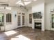 Cozy sunroom with tile flooring, a fireplace, and multiple access points to the outdoors at 101 Temple Gate Dr, Cary, NC 27518