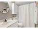 Well-lit bathroom featuring a vanity, toilet, shower with white curtain, and a clean design at 103 Uxbridge Ct, Cary, NC 27513