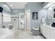 This bathroom showcases a soaking tub, a glass-enclosed shower, and white marble floors at 103 Uxbridge Ct, Cary, NC 27513