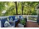 Deck with wicker furniture and blue cushions with trees providing shade at 103 Uxbridge Ct, Cary, NC 27513
