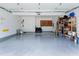Spacious garage with epoxy flooring, a tool rack, and shelving for ample storage space at 103 Uxbridge Ct, Cary, NC 27513