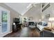 This living room has vaulted ceilings, a fireplace, and access to the back deck at 103 Uxbridge Ct, Cary, NC 27513