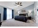 This spacious bedroom features blue accent walls, a ceiling fan, and large windows for natural light at 103 Uxbridge Ct, Cary, NC 27513
