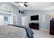Spacious main bedroom featuring a dark dresser, television, and ensuite bathroom at 103 Uxbridge Ct, Cary, NC 27513