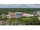 Bird's eye view of a modern hospital complex surrounded by trees and a parking lot, set against a backdrop of distant hills at 104 Deer Park Ln, Cary, NC 27518