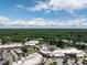 Overhead image of a commercial center with many retailers, lots of parking, and green space, with a clear skyline in the distance at 104 Deer Park Ln, Cary, NC 27518