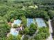 The community pool and tennis courts are highlighted in this lush aerial view at 104 Deer Park Ln, Cary, NC 27518
