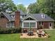 Relax on the stone patio in the backyard, complemented by a lush lawn and charming brick house at 104 Deer Park Ln, Cary, NC 27518