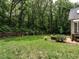 The spacious backyard is ideal for entertaining, featuring a patio set and well-maintained lawn at 104 Deer Park Ln, Cary, NC 27518