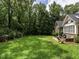 Expansive backyard with lush green grass and mature trees, perfect for outdoor activities and relaxation at 104 Deer Park Ln, Cary, NC 27518