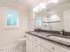 This bathroom features double sinks with granite counters, a window and a glass shower at 104 Deer Park Ln, Cary, NC 27518