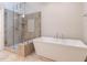 Modern bathroom featuring a soaking tub and a walk-in shower with glass door at 104 Deer Park Ln, Cary, NC 27518
