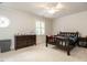 This bedroom offers a ceiling fan, shutters on the window, and neutral carpet at 104 Deer Park Ln, Cary, NC 27518