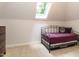 This bedroom features a skylight and neutral carpet that complements the white walls at 104 Deer Park Ln, Cary, NC 27518