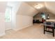 Large bonus room with a window, carpet, and an area with a bar for entertaining at 104 Deer Park Ln, Cary, NC 27518