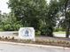 Lochmere Golf Club sign featuring a gazebo illustration surrounded by colorful landscaping in a well-maintained community at 104 Deer Park Ln, Cary, NC 27518