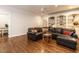 Spacious den with hardwood floors, built-in shelving, and comfortable seating at 104 Deer Park Ln, Cary, NC 27518