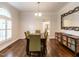 Elegant dining room with hardwood floors, decorative mirror, and lots of natural light at 104 Deer Park Ln, Cary, NC 27518