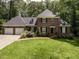 Attractive brick home with a two-car garage, lush landscaping, and inviting front entrance at 104 Deer Park Ln, Cary, NC 27518