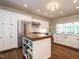 Spacious kitchen boasts stainless appliances, granite countertops, white cabinetry, and large kitchen island at 104 Deer Park Ln, Cary, NC 27518