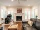 Bright living room with white fireplace, hardwood floors, and comfortable seating at 104 Deer Park Ln, Cary, NC 27518