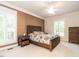 Cozy main bedroom with accent wall, two windows with plantation shutters, and hardwood furniture at 104 Deer Park Ln, Cary, NC 27518