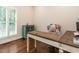 Bright office space featuring hardwood floors, white trim, and a large window with plantation shutters at 104 Deer Park Ln, Cary, NC 27518
