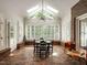Bright sunroom with brick floors, skylights, and large windows at 104 Deer Park Ln, Cary, NC 27518