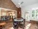 Inviting sunroom with brick floors, large windows, and connected to the kitchen at 104 Deer Park Ln, Cary, NC 27518