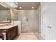 Modern bathroom showcasing a spacious glass-enclosed shower with tile surround and gold fixtures at 10405 Veasey Mill Rd, Raleigh, NC 27615