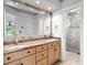 Bathroom featuring double sinks, a granite countertop, and a glass-enclosed shower at 10405 Veasey Mill Rd, Raleigh, NC 27615