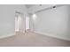 Neutral bedroom featuring carpet floors and white walls with views of an entryway and closet at 10405 Veasey Mill Rd, Raleigh, NC 27615