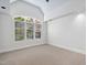 Bright bedroom with vaulted ceilings, neutral carpet, and large window with shutter blinds at 10405 Veasey Mill Rd, Raleigh, NC 27615